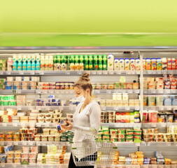 supermarket shopping, face mask and gloves,Woman choosing a dairy products at supermarket