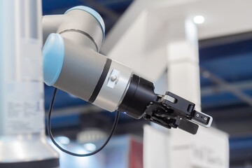 Close up view of moving futuristic robotic clamp arm at robot exhibition. Future, engineering, cybernetic, science and robotic concept