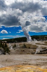 Fototapeta na wymiar Geyser Old Faithful erupts in Yellowstone National Park in Wyoming, US