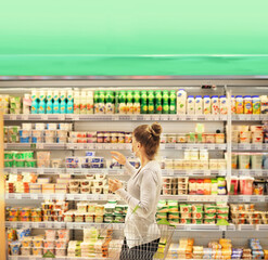 Woman choosing a dairy products at supermarket