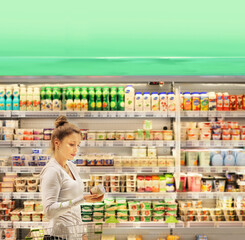 Woman choosing a dairy products at supermarket