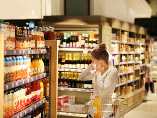 supermarket shopping, face mask and gloves,Woman choosing a dairy products at supermarket