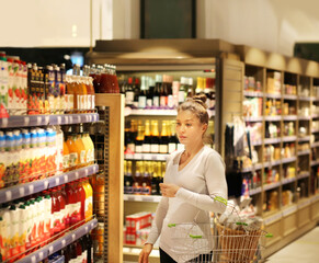 Woman choosing a dairy products at supermarket