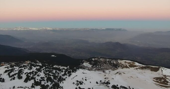 Foggy Alpine landscape at Chamrousse France during morning sunrise showing pastel colors, Aerial slow pan left shot