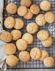 Oatmeal cookies on black metal grille, wooden background. Healthy vegan cookies. Top view.