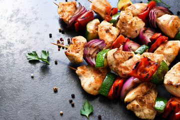 Chicken shashlik and vegetables: peppers, onions, zucchini on skewers. Chicken fillet and grilled...