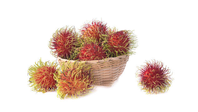 Rambutans in bomboo basket isolated on white background