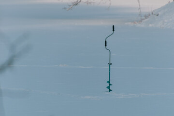 Ice fishing equipment in the snow.