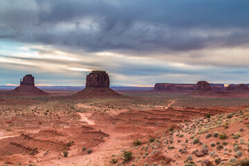 dramatic landscape photo of the spectacular mesa and buttes and rock formations in Monument Valley in the border of Utah and Arizona.