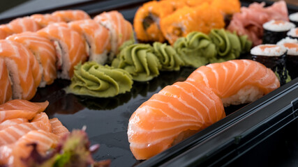 Close-up of fresh rolls and sushi set. Japanese cuisine. Tasty food. Fish and rice.