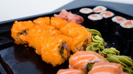 Close-up of fresh rolls and sushi set. Japanese cuisine. Tasty food. Fish and rice.