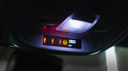 Passenger airbag status warning light on display of a car console. - obrazy, fototapety, plakaty
