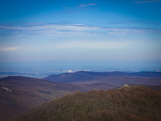 clouds, blue sky, haze over the mountains.