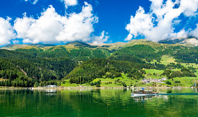 Fototapeta na wymiar Passenger boat on Reschensee, an artificial lake in South Tyrol, the Italian Alps