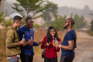 group of young african friends having a get together party, having drinks and discussion
