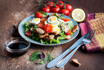 Salad with mussels, tomatoes, eggs, arugula, basil, spinach, lemon and croutons on dark brown background. Seafood salad with vine sauce