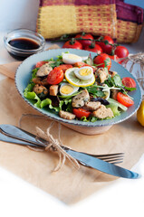 Salad with mussels, tomatoes, eggs, arugula, spinach, lemon and croutons on white background. Seafood salad with vine sauce