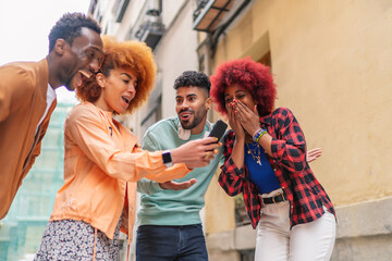 group of friends smiling while looking at a smartphone