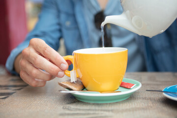 young woman enjoys a cup of tea