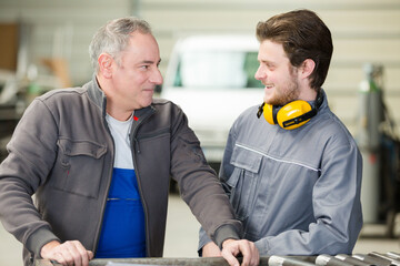 portrait of two smiling garage workers