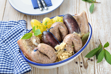 Bayerische Schlachtplatte mit Blut- und Leberwurst, Wammerl, Sauerkraut und Kartoffeln – Bavarian meat and sausage platter with black pudding and liverwurst, belly of pork, potatoes and sauerkraut