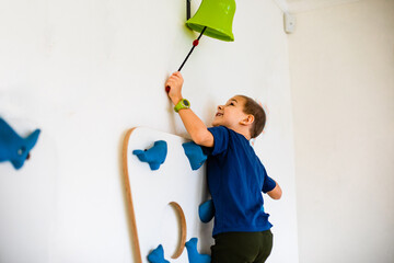 The kids play a dexterity game are climbing a wall