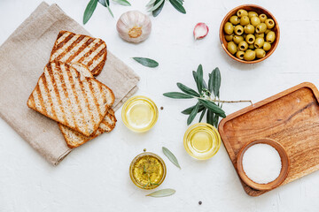  Green olives, olive oil and ciabatta bread. Top view flat lay with copy space