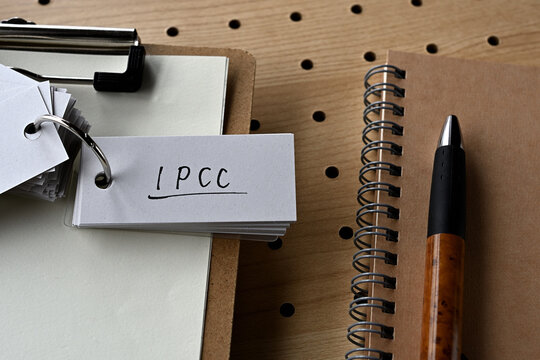 There's a notebook, and a clipboard with a wordbook on it that says IPCC.