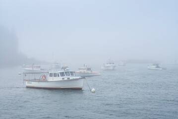 Obraz na płótnie Canvas USA, Maine, Port Clyde. Port Clyde Harbor, boats in the fog.