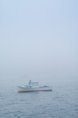 Fototapeta na wymiar USA, Maine, Port Clyde. Port Clyde Harbor, boats in the fog.