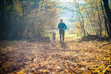 trail runner and his dog running