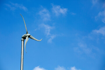 Renewable energy propeller with blue sky - Text space
