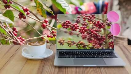 cup of coffee and laptop on wooden table