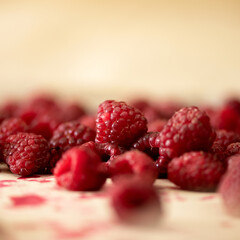 Fresh Raspberries background or texture. Close up shot. Group of red berries at table. Natural organic Healthy food. Sweet summer vegetarian or vegan dessert. Square format,1x1.