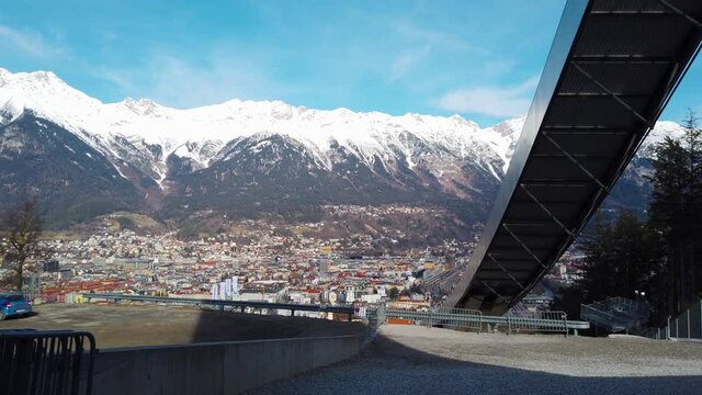 The stadium of the ski jumping hill tower and the track. In the background the city of Innsbruck