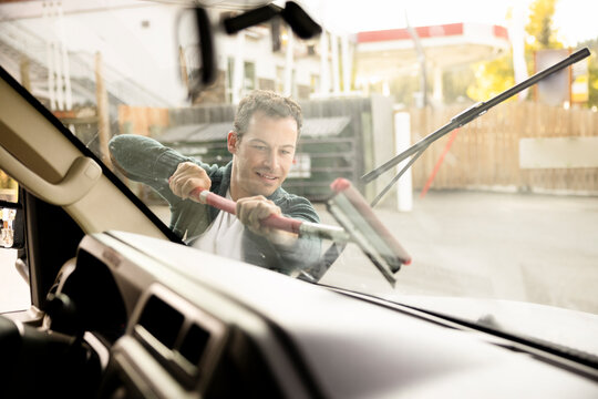 View Through RV Windshield Of Man Cleaning