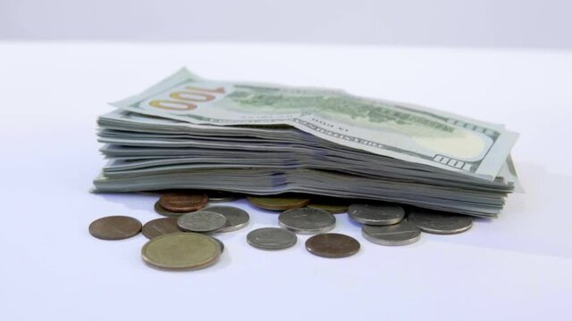 stack of dollars falling onto coins