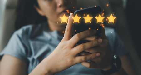 close up on customer woman hand pressing on smartphone screen with five star rating feedback...