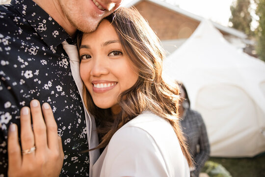 Portrait Of Young Newlyweds Hugging