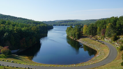 Fototapeta premium Overlook of beautiful peaceful lake surrounded by mountains in early autumn.