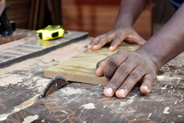Black African carpenter working with carpentry  equipment in a  carpenter's workshop
