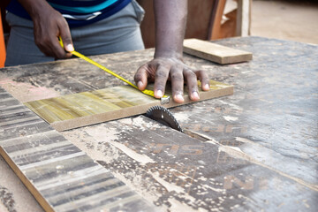 Black African carpenter working with carpentry  equipment in a  carpenter's workshop
