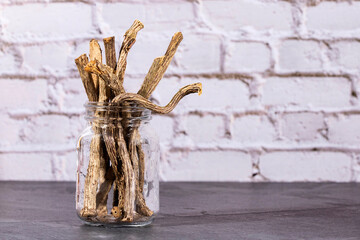 Valeriana officinalis - Dried stems of medicinal valerian in the glass jar