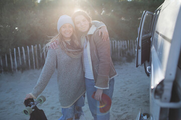 Portrait happy young women friends outside sunny camper van