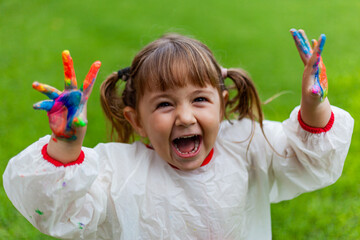 girl playing with colored paints