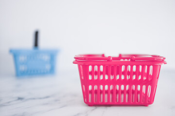 Fototapeta premium couple of shopping baskets with different shapes and color for different brand or stores, competition and retail industry