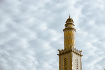 Mosque minaret with cloud sky on background. With empty space for text marhaban ya ramadan or...