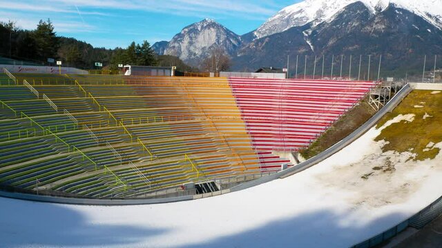 The stadium of the ski jumping hill tower and the track. In the background the city of Innsbruck