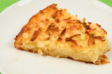 Whole cassava cake on green fabric background