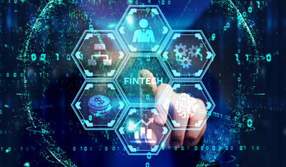 Fintech -financial technology concept.Young businessman  select the icon Fintech on the virtual display.